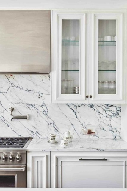 White kitchen cabinets with marble backwash